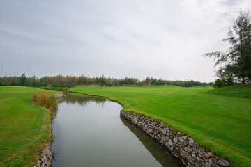 Stream between meadows on a gloomy day