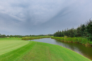 Empty golf course with lake view on a gloomy day