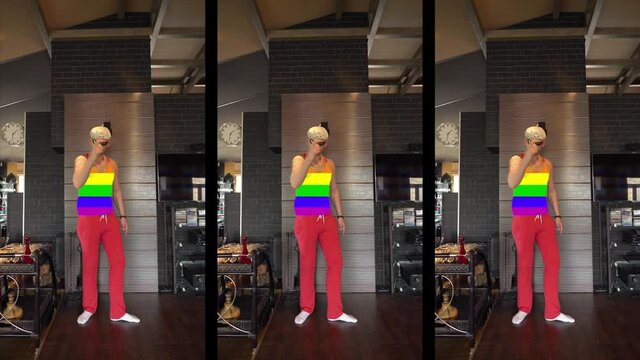 Young gay guy in a cool T-shirt with LGBT flag movement, gay sexy unusual guy fooling around on camera, bored at home. Funny dance from a freaky guy. Vertical video for social networks. 4к