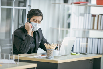 Business man use smartphone and wearing face mask for protect coronavirus covid-19 pandemic. Social...