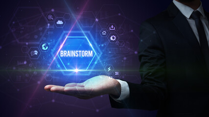 Man hand holding BRAINSTORM inscription, social media concept