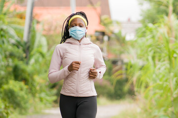 post quarantine runner girl enjoying outdoors workout - young attractive and fit black afro...