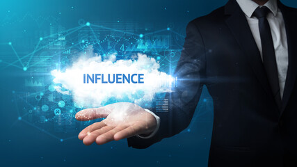 Hand of Businessman holding INFLUENCE inscription, successful business concept