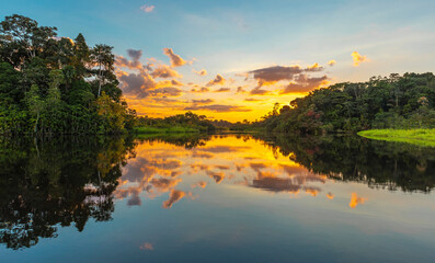 Panorama of a sunset in the Amazon Rainforest which comprise the countries of Brazil, Bolivia,...