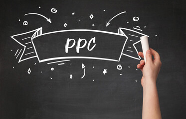 Hand drawing PPC abbreviation with white chalk on blackboard