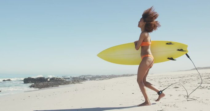 African American woman ready to go surf