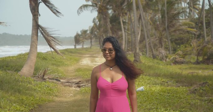 Very sexy Caribbean model walks the coastline of this beach escape on the Caribbean island of Trinidad