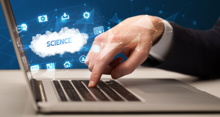 Obraz premium Businessman working on laptop with SCIENCE inscription, modern technology concept