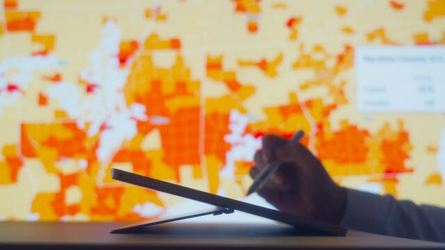 Scientists look at Covid-19 map of the USA on computer