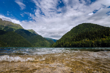 Naklejka na ściany i meble A mountain lake on a warm summer sunny day. mountains of the Caucasus