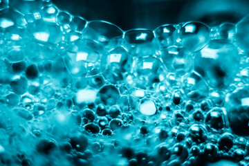 bubbles soap on water surface, shine with a bright, shimmering reflected light.