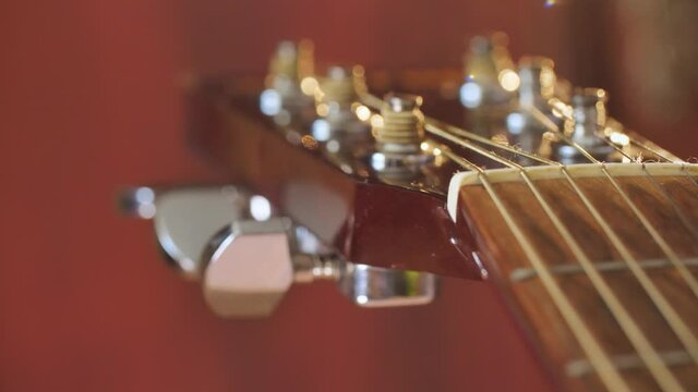 Close Up of Tuning Peg on Acoustic Guitar Headstock
