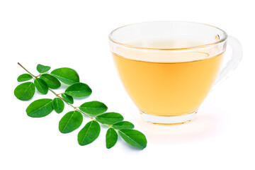Glass cup of moringa tea with green leaf isolated on white background.