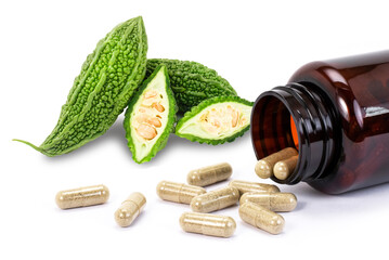 Closeup bitter gourd or bitter melon powder medicine capsules pill isolated on white background.