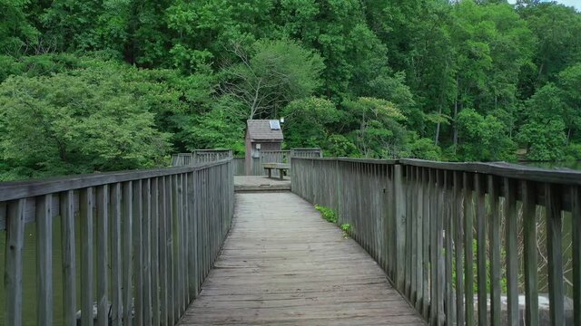 Walking Bridge Over A Small Waterfall Separating Garrett Lake And Lake Cherful At Mountain Park In Roswell Georgia