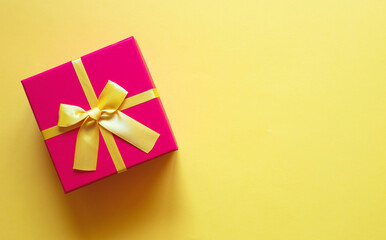 gift box with bow on yellow background