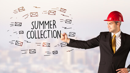 Handsome businessman with helmet drawing SUMMER COLLECTION inscription, contruction sale concept