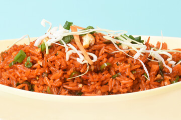 Schezwan fried rice with schezwan sauce, Chinese fried rice,garnished with spring onion and cabbage.indo chinese cuisine dishes.selective focus