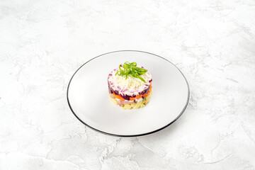 Vinaigrette salad on a white, round, glass plate
