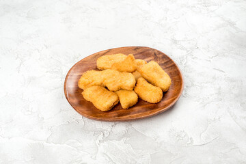 Nuggets in a wooden plate shot on a background