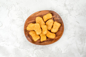 Nuggets in a wooden plate shot on a background