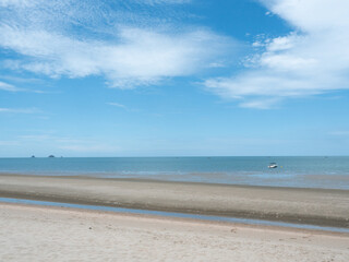 Fototapeta na wymiar Beach with sea smooth and white cloud on beautiful blue sky , Fluffy clouds formations at tropical zone , Holiday activities on the sand at Pranburi Beach , Thailand