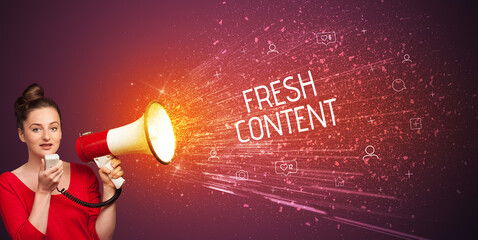 Young woman yelling to loudspeaker with FRESH CONTENT inscription, social networking concept