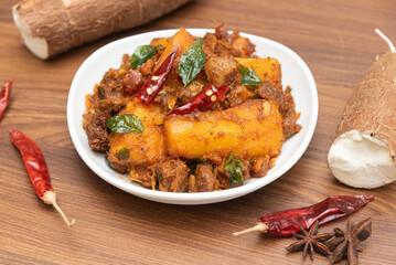 Popular traditional South Indian food  Kappa or tapioca biryani hot and spicy dish made with cooked organic cassava root, grated coconut, beef or steak and Kerala, India. staple food Brazil.