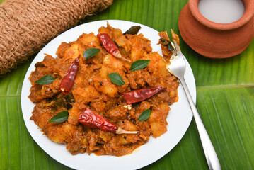 Popular traditional South Indian food  Kappa or tapioca biryani hot and spicy dish made with cooked organic cassava root, grated coconut, beef or steak and Kerala, India. staple food Brazil.