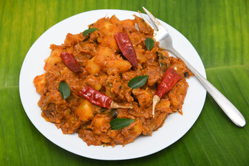 Popular traditional South Indian food  Kappa or tapioca biryani hot and spicy dish made with cooked organic cassava root, grated coconut, beef or steak and Kerala, India. staple food Brazil.