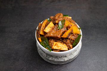 Beef fry curry roast mutton curry meat dish Kerala, India. Hot and spicy homemade side dish of Kappa biryani , Appam, Parotta, Puttu. South Indian non veg food
