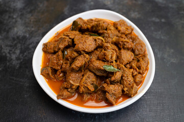 Beef fry curry roast mutton curry meat dish Kerala, India. Hot and spicy homemade side dish of Kappa biryani , Appam, Parotta, Puttu. South Indian non veg food