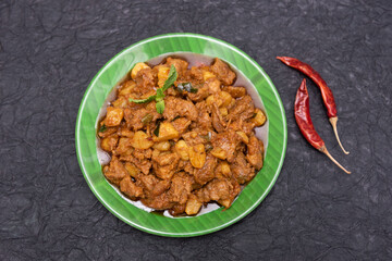 Beef fry curry roast mutton curry meat dish Kerala, India. Hot and spicy homemade side dish of Kappa biryani , Appam, Parotta, Puttu. South Indian non veg food