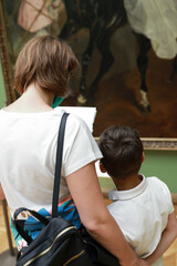 Mother with her son wearing protection mask in museum