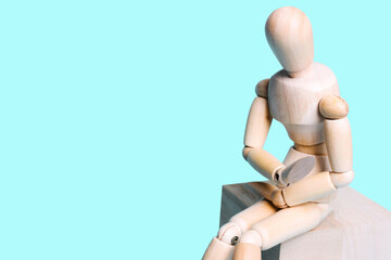 Wooden human figure on a blue background.