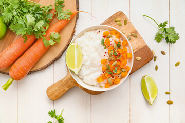 Bowl with boiled rice and pumpkin on table
