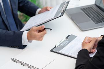 confident businessman sitting in front of office manager talk conducting to interviewer with colleague or boss for business