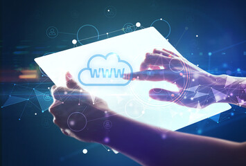 Hand holdig futuristic tablet with WWW inscription, modern technology concept