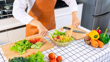 Asian woman is preparing healthy food vegetable salad at light kitchen Cooking At Home and healthy food concept
