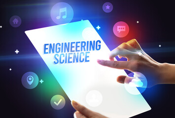 Holding futuristic tablet with ENGINEERING SCIENCE inscription, new technology concept