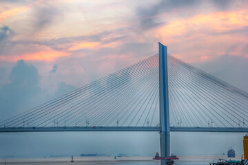 A bridge crosses the sea at sunrise and sunset in hainan, China.