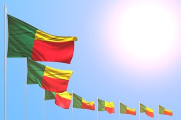 nice many Benin flags placed diagonal on blue sky with place for your content - any celebration flag 3d illustration..