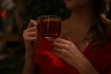 young beautiful girl drinks tasty tea with lemon