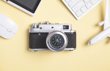 Compass and other objects on the yellow background. Travel