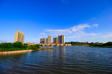 Fototapeta premium Green living building residential area under the blue sky and white clouds.