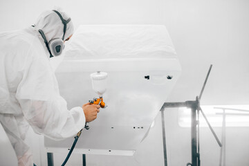 Automotive industry concept. Painting door of a car with compressor.