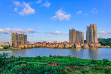 Obraz premium Green living building residential area under the blue sky and white clouds.
