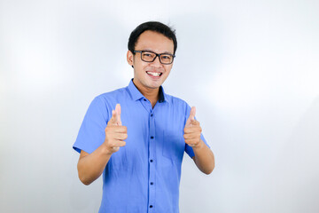 Young Asian man wear blue shirt and glasses with happy smiling face and thumbs up