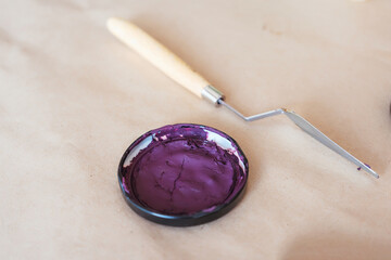 Palette knife and cover from a can of paint close-up. Creative workshop for artists, decorators,...