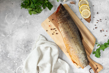 Sockeye salmon. Sockeye salmon on a serving Board on a light gray kitchen table. Smoked sockeye salmon on a serving Board. Top view with space for text